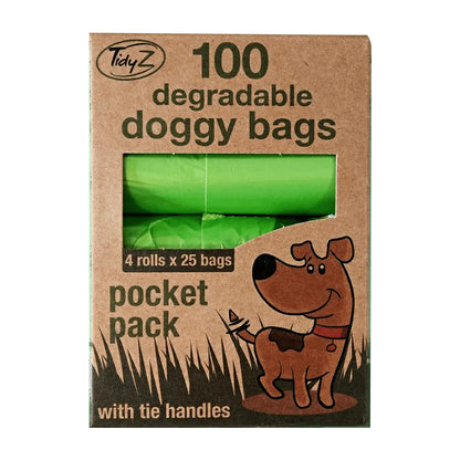 Green degradable doggy bags in a pocket pack, featuring four rolls of 25 bags, displayed in a cardboard box with a playful dog graphic.